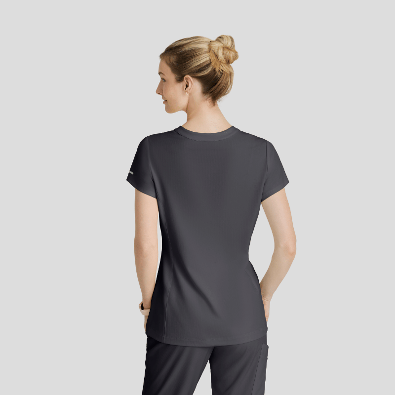 Woman wearing a gray scrubs on a light gray background