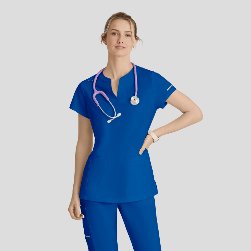 Person wearing a blue scrub set with a stethoscope on a light gray background